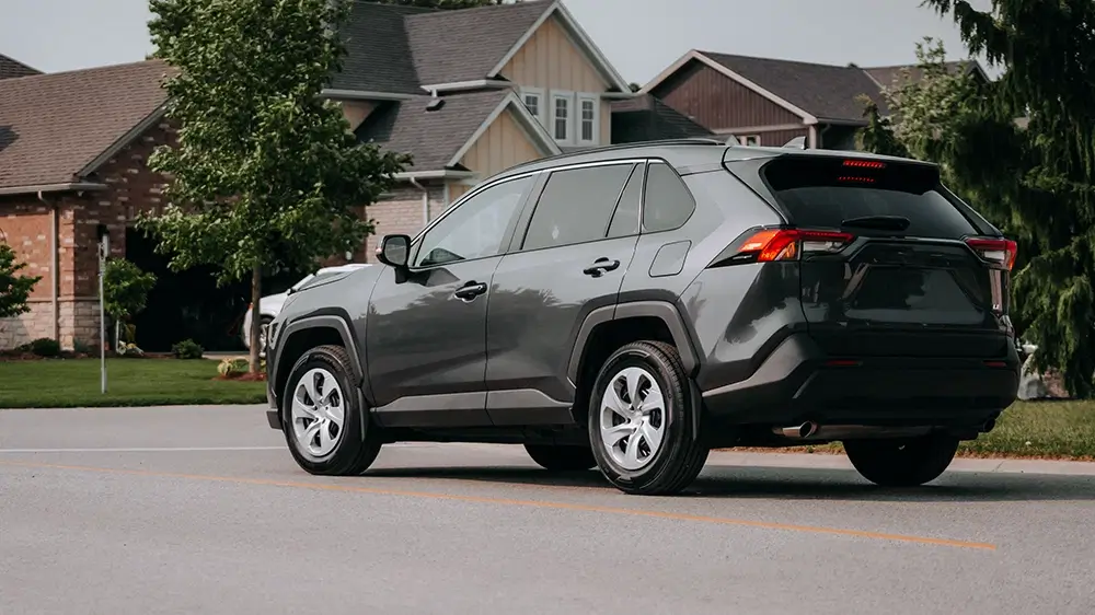 Gray SUV parked on a residential street, showcasing its stylish design and all season tires.
