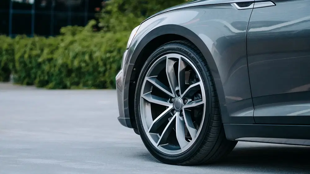 Stylish vehicle with performance tires showcasing a sleek design and modern alloy wheels.